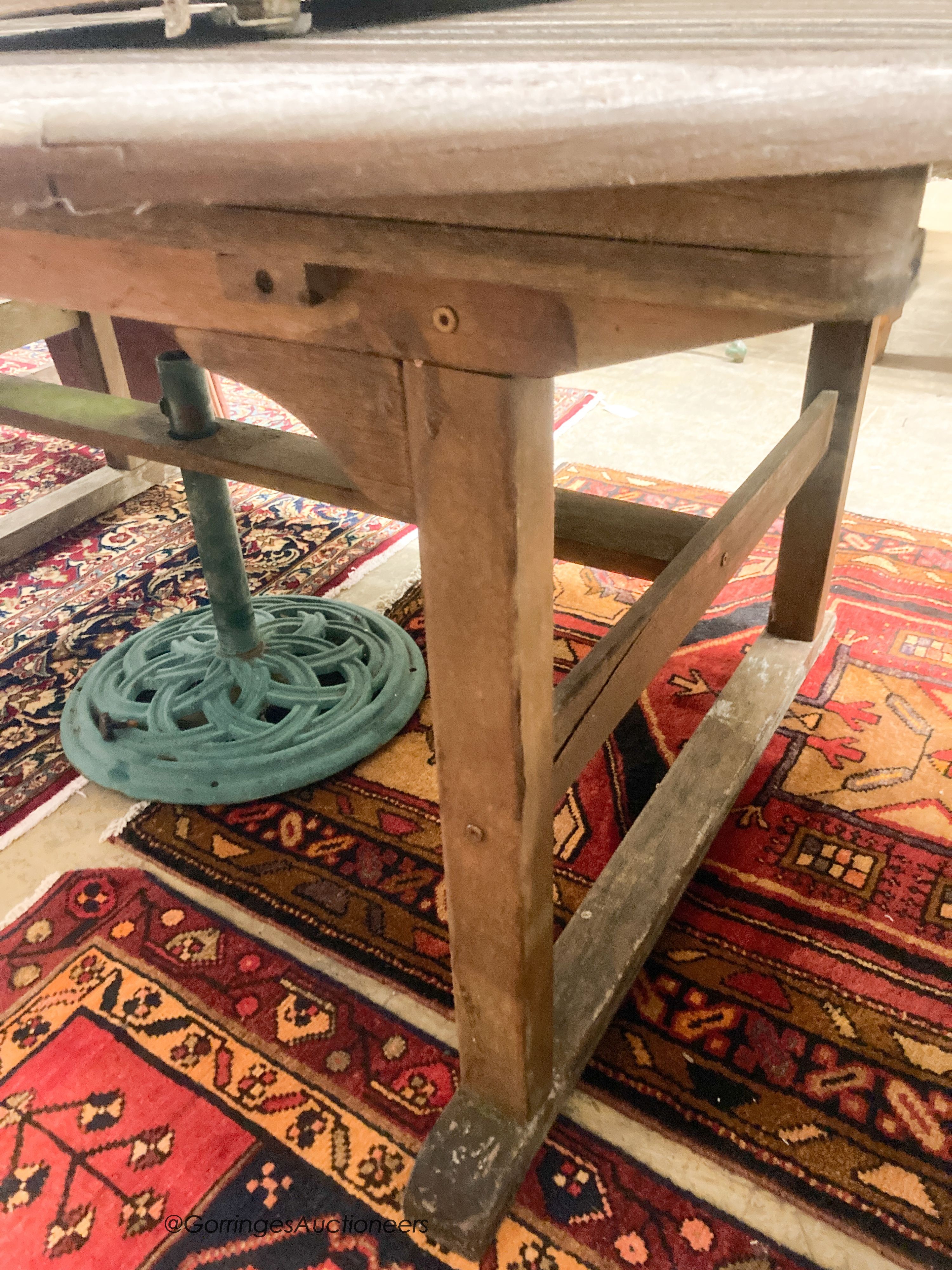 A weathered teak extending garden table, length 190cm, depth 120cm, height 74cm a bench and four weathered teak armchairs